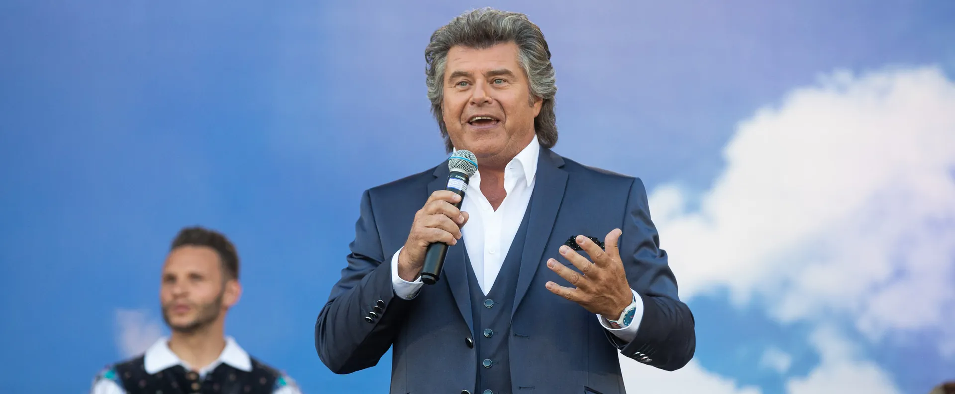 Sänger mit Mikrofon auf einer Open-Air-Bühne